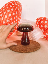 mushroom shaped cup with hand to show scale